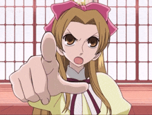 a girl with a pink bow on her head points her finger