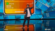 a man stands in front of a phone screen that says phone mom missed call on it