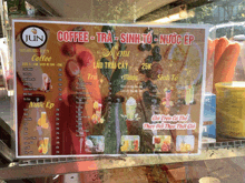 a menu for jun coffee is displayed on a glass counter