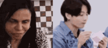 a man and a woman are sitting next to each other in a kitchen . the woman is crying and the man is eating .