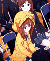 a girl wearing a cat hooded jacket sits in a crowd of people
