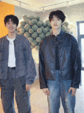 two young men standing next to each other with one wearing a jacket that says ' abercrombie & fitch ' on it