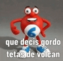 a red toy with a blue number 6 on it is standing on a gray surface with a caption .