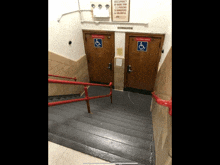 a staircase leading to a gymnasium with a sign on the wall