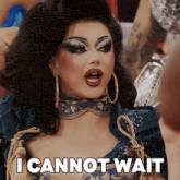 a drag queen says " i cannot wait " in front of her