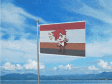 a flag with a cartoon character on it flying in the wind