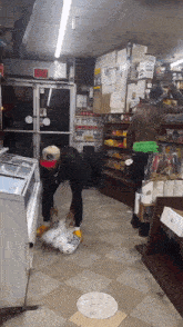a man standing in a store with an exit sign above him