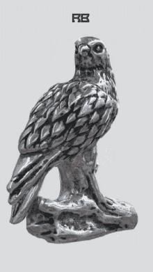 a statue of a bird with the letters rb on the bottom