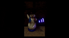 a snowman with a blue light behind it