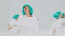 a woman with green hair is wearing a white shirt that says nmc