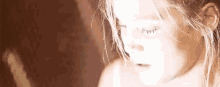 a close up of a girl 's face with her eyes closed .