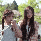 two girls are standing next to each other with one wearing a shirt that says ' i love you '
