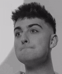 a close up of a young man making a face