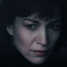 a close up of a woman 's face with a sad look on her face