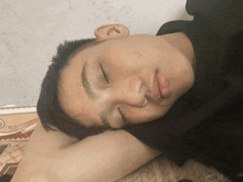 a young man sleeping with his eyes closed