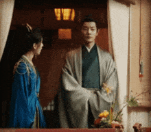 a man and a woman standing next to each other in a room