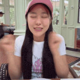 a woman wearing a pink hat and a t-shirt that says ' i love you '