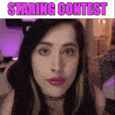 a close up of a woman 's face with the words staring contest written above her