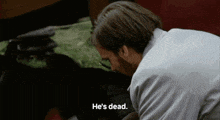 a man says he 's dead while looking at a dog