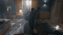 a man and a woman standing in a dark room