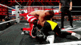 two men are wrestling in a ring with a referee watching