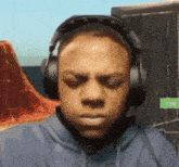 a man is wearing headphones and making a face