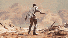 a man in a cape is holding a gun in a desert landscape