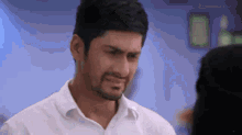 a man is crying while looking at a woman .
