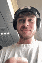 a man wearing headphones and a jets hat
