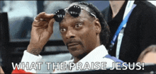 snoop dogg wearing sunglasses with the words what the praise jesus below him