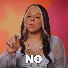 a woman wearing a necklace says no with her hand