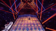 a man and woman are dancing on a stage with skulls on it