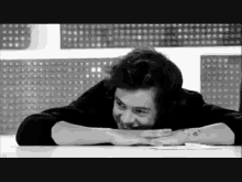 a man with a tattoo on his wrist is laying on a table