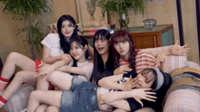 a group of girls laying on a couch with one wearing a t-shirt that says " i love you "