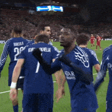 a soccer player wearing a qatar airways jersey is surrounded by other players