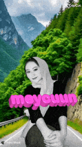 a woman in a hijab is sitting on the side of a road with the word meycuum written on her chest