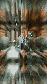 a blurry picture of a man in a suit and tie holding a gun