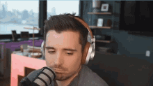 a man wearing headphones looks at the camera