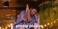 a man is sitting in a chair with his hands folded in prayer and the words `` pretty please '' above him .