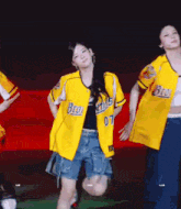 a girl in a yellow jersey with the number 07 on it is dancing