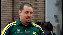 a man wearing a green and yellow shirt that says ' icc cricket world cup ' on it