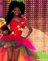 a woman in a colorful dress with a bunch of balls around her neck .