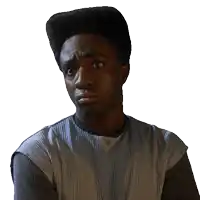 a man with a very high top hairstyle is wearing a striped shirt