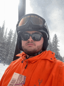 a man wearing a helmet and sunglasses is holding a ticket that says " pillow "