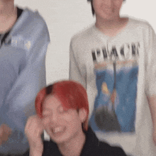 a man with red hair is wearing a white shirt that says peace
