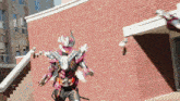 a superhero is standing in front of a brick building with stairs