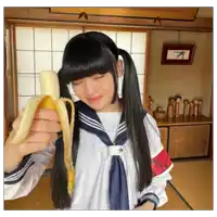 a girl with pigtails is holding a banana