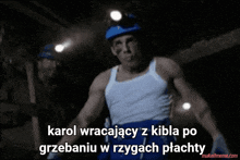 a man in a white tank top and blue shorts is standing in a dark room with a caption that says karol