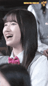 a girl is laughing with the words watch full video on jk48 tv below her
