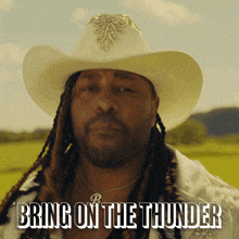 a man with dreadlocks wearing a cowboy hat says " bring on the thunder "